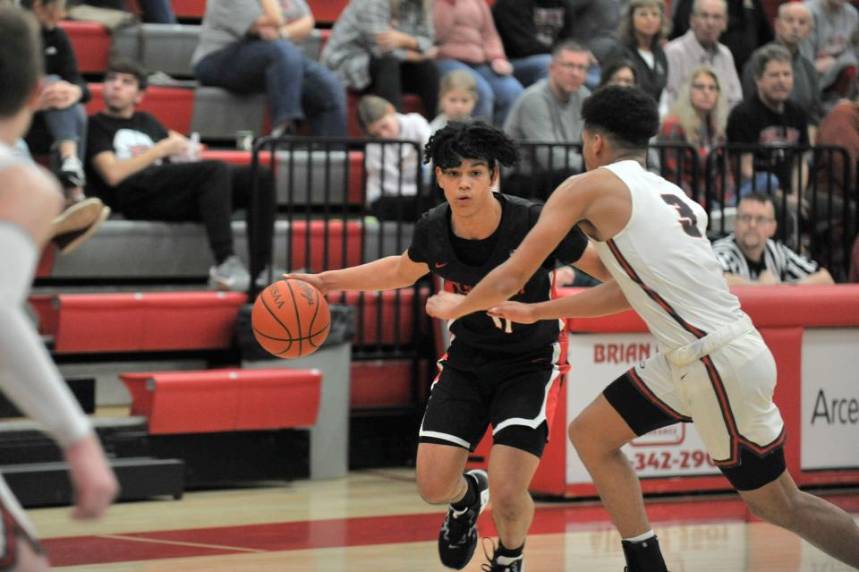 Pleasant's Trey Booker dribbles the ball against Shelby's defense during a road boys basketball game this season.