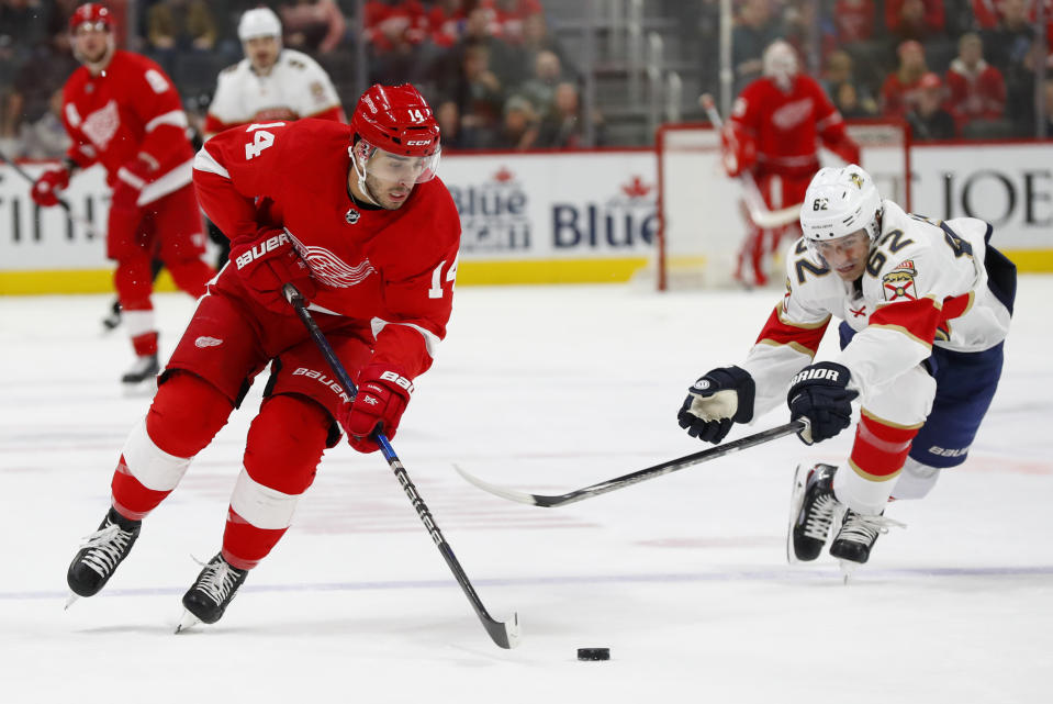 Detroit Red Wings center Robby Fabbri (14) attacks with the puck as Florida Panthers center Denis Malgin (62) tries to make a steal during the first period of an NHL hockey game Saturday, Jan. 18, 2020, in Detroit. (AP Photo/Paul Sancya)