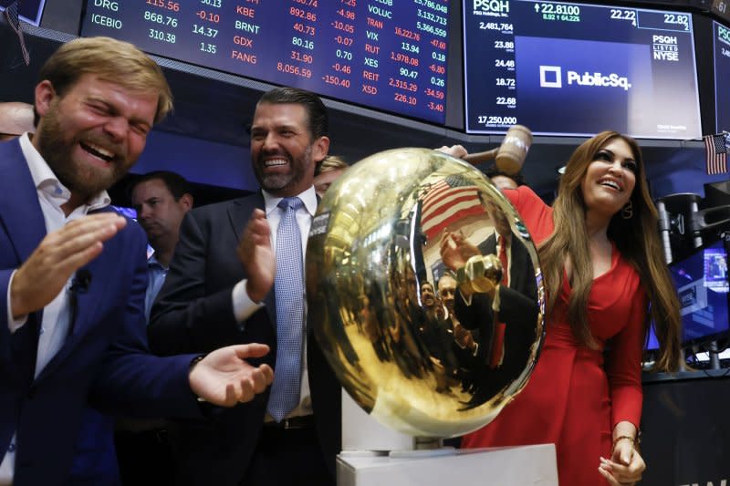 PublicSq Founder and CEO Michael Seifert (L) is joined by Donald Trump Jr. and Kimberly Guilfoyle (R) as they ring the ceremonial bell for trading to begin at the New York Stock Exchange. Photo by John Angelillo/UPI