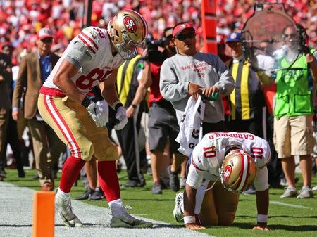 Sep 23, 2018; Kansas City, MO, USA; San Francisco 49ers tight end George Kittle (85) attends to quarterback Jimmy Garoppolo (10) in the second half against the Kansas City Chiefs at Arrowhead Stadium. Mandatory Credit: Jay Biggerstaff-USA TODAY Sports