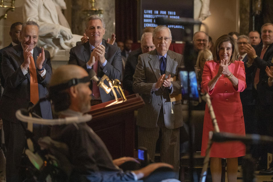 House Speaker Nancy Pelosi and Senate Majority Leader Mitch McConnell of Ky., and other Congressional leadership other members of Congress applaud during a Congressional Gold Medal ceremony honoring amyotrophic lateral sclerosis (ALS) advocate and former National Football League (NFL) player, Steve Gleason, in Statuary Hall on Capitol Hill, Wednesday, Jan. 15, 2020, in Washington. (AP Photo/Manuel Balce Ceneta)