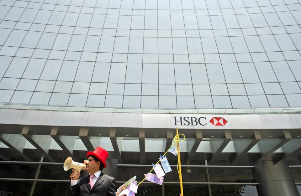 A man wearing a pig nose and holding fake, laundered banknotes during a protest in front of a HSBC branch building in Mexico City (AFP/Getty)