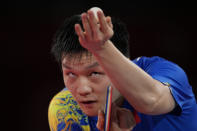 Fan Zhendong of China eyes the ball during a gold medal match of the table tennis men's singles against Ma Long of China at the 2020 Summer Olympics, Friday, July 30, 2021, in Tokyo. (AP Photo/Kin Cheung)