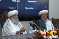 Taliban Prime Minister Mohammad Hasan Akhund, left, speaks during an economic conference at the former Presidential Palace in Kabul, Afghanistan, Wednesday, Jan. 19, 2022. Afghanistan's Taliban rulers are holding their first economic conference, five months since taking over the country that is now teetering on the verge of a humanitarian catastrophe and economic collapse. The U.N. head of mission for Afghanistan said at the gathering on Wednesday that surprising $1 billion in exports. (Taliban Prime Minister Media Office via AP)