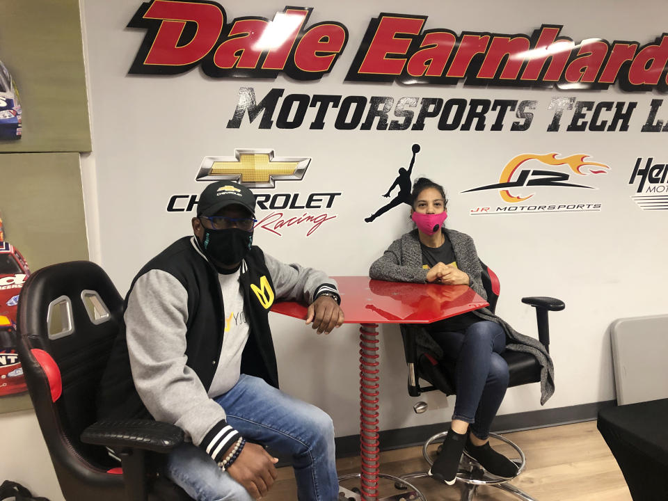 Urban Youth Racing School founder Anthony Martin, left, and his wife Michelle Martin pose for a photo at the school, Friday, Oct. 30, 2020, in Philadelphia. The school has made it its mission to introduce inner-city youngsters, most of them black, to the motorsports world. (AP Photo/Dan Gelston)