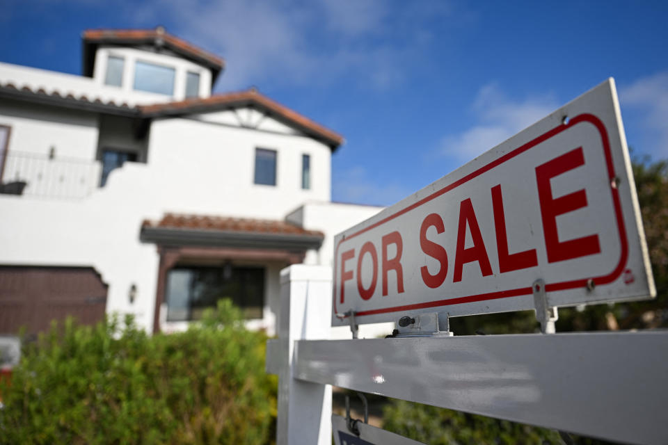 A for sale sign is displayed outside of a home. (Photo by PATRICK T. FALLON/AFP via Getty Images)