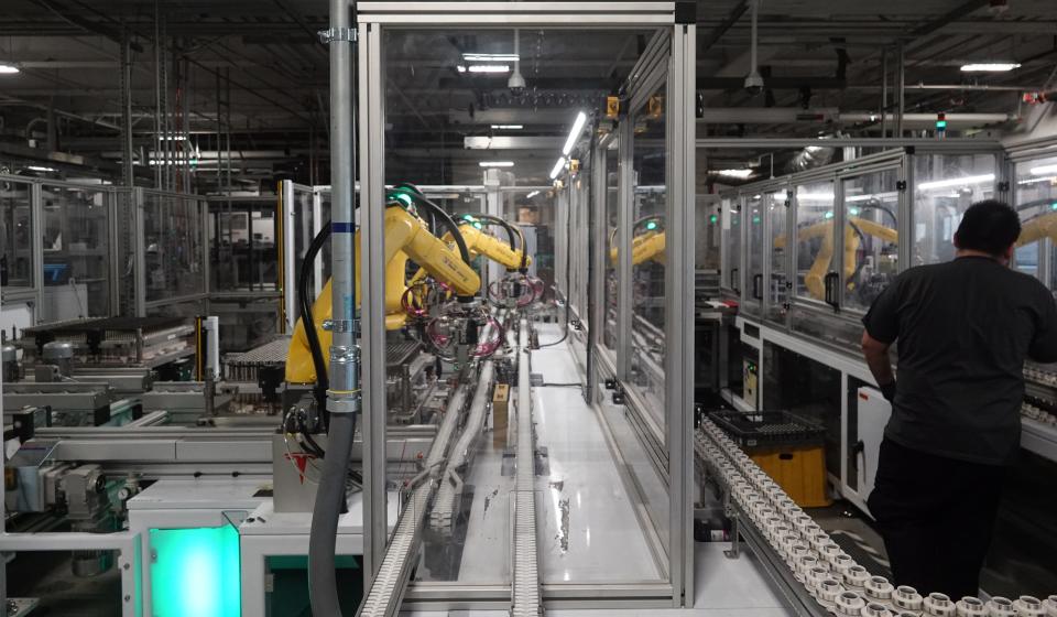 Robots at the Tesla Gigafactory help assemble battery cells from Panasonic into battery packs for Tesla's Model 3 sedan and other products on Dec. 3, 2018.