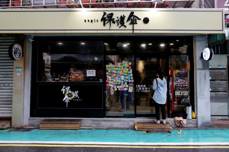 A customer about to enter Aegis, a restaurant that offer work opportunities to Hong Kongers seeking asylum in Taipei,