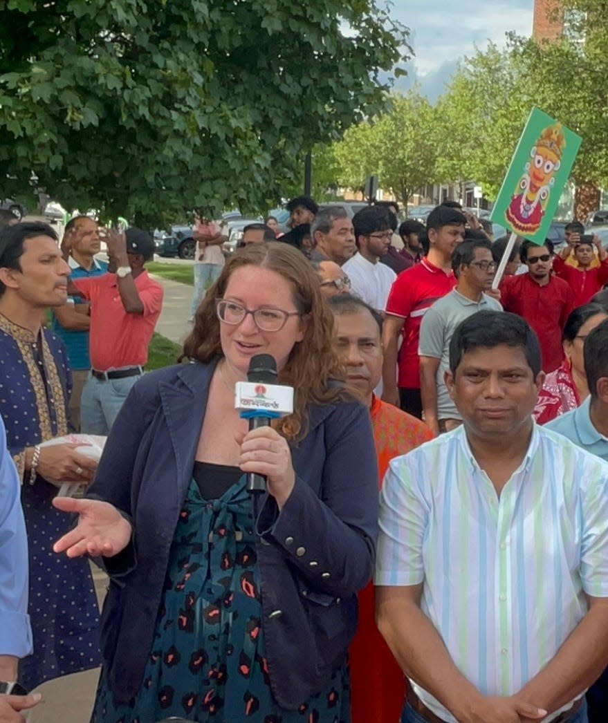Hamtramck city council candidate Lynn Blasey, left, speaks to news media at Ratha Yatra procession on July 2, 2023, at Zussman Park. On her left is Councilman Abu Musa. The Bangladeshi-American Hindu community organized the parade.