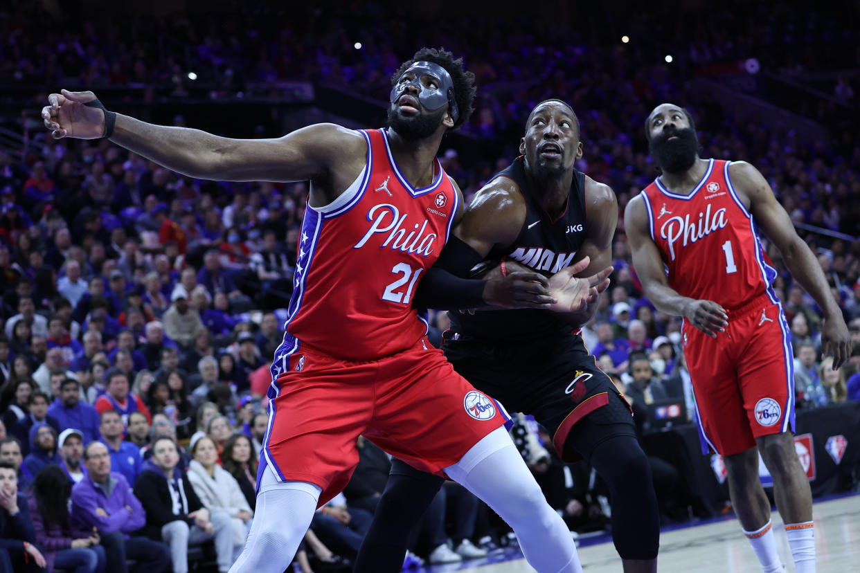 Joel Embiid of Philadelphia 76ers and Bam Adebayo of Miami Heat fight for a rebound while James Harden looks on during an NBA playoff game on May 8. (Tayfun Coskun/Getty Images)