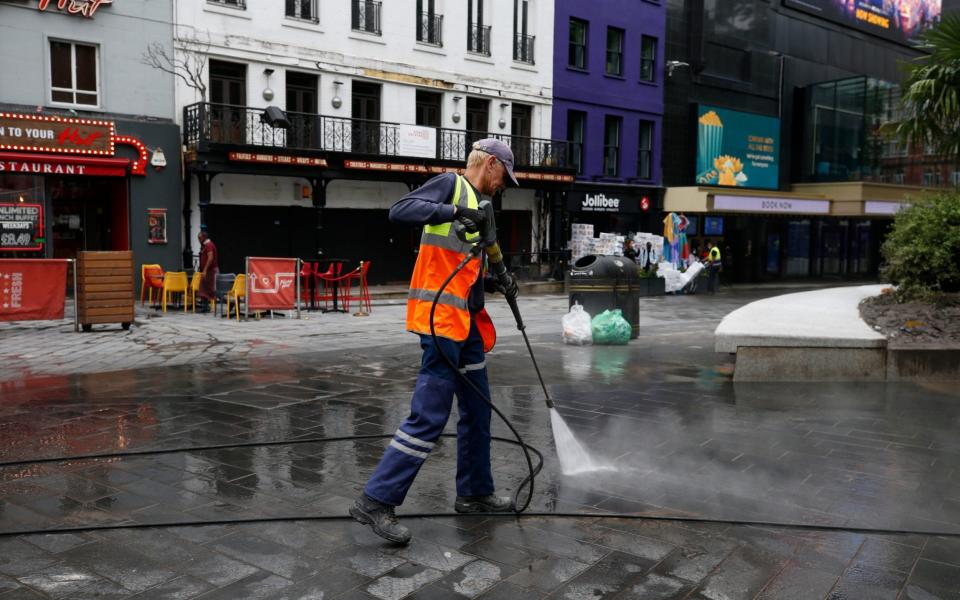 A Cit of Westminster worker cleans up after football fans at Leicester Square on June 19, 2021 in London, England. England and Scotland drew 0-0 in the Euro 2020 match at Wembley  - GETTY IMAGES