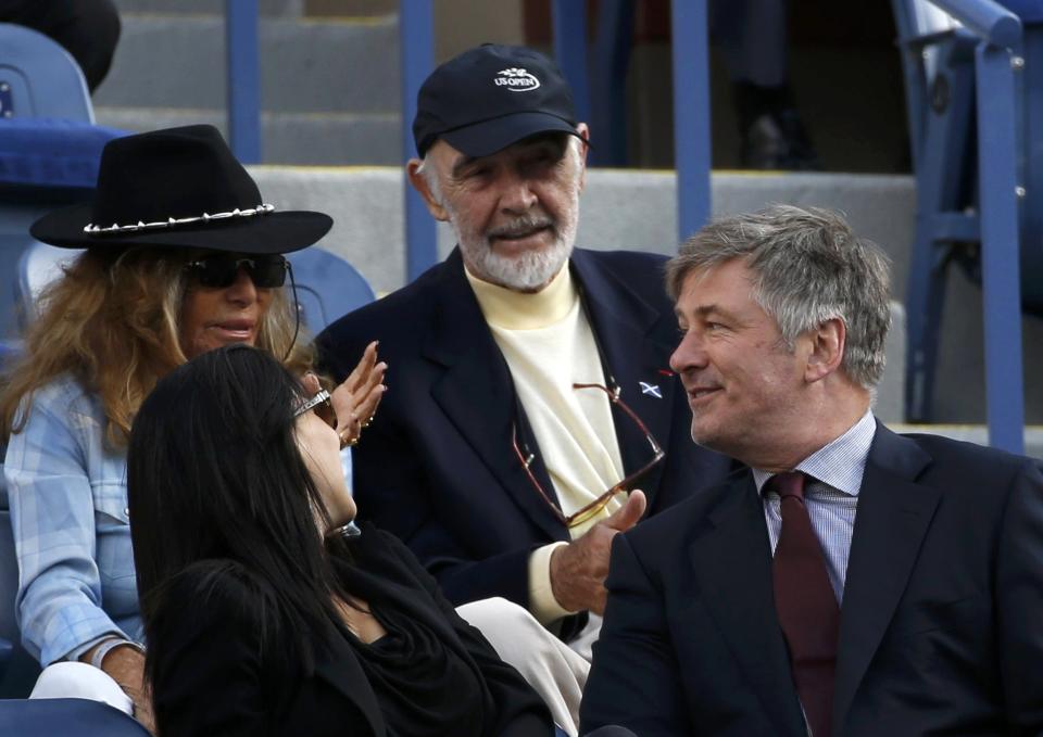 Actors Alex Baldwin (R) and Sean Connery (C) chat as they watch Rafael Nadal of Spain face Novak Djokovic of Serbia in the men's final match at the U.S. Open tennis championships in New York, September 9, 2013. REUTERS/Mike Segar (UNITED STATES - Tags: SPORT TENNIS ENTERTAINMENT)