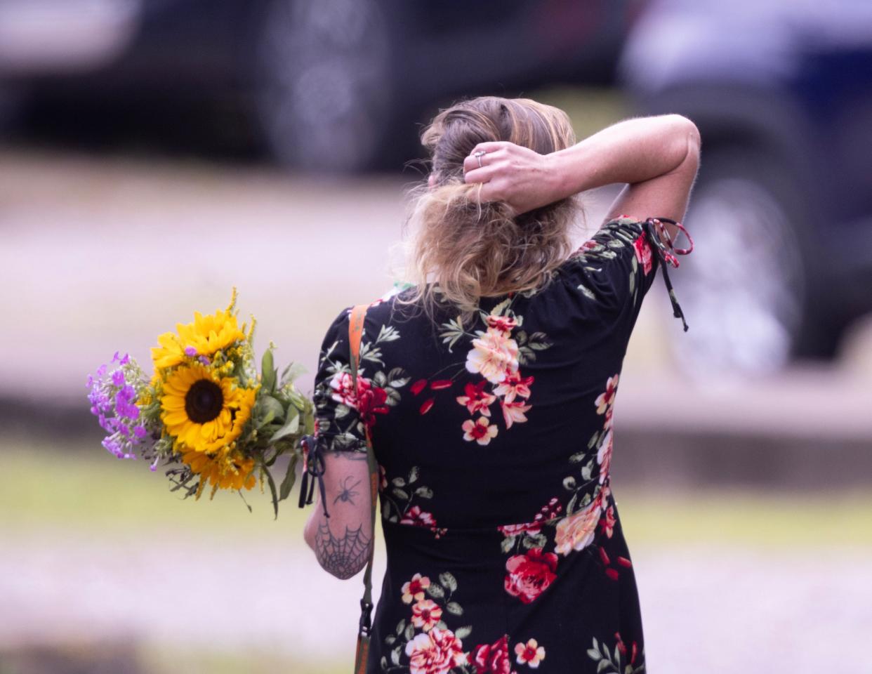 A mourner walks across the parking lot to Laube Hall in Freeport, Pennsylvania, where the calling hours for Corey Comperatore took place Thursday. Comperatore died shielding his family from a would-be assassin's bullets that were aimed at former President Donald Trump during a rally Saturday.
