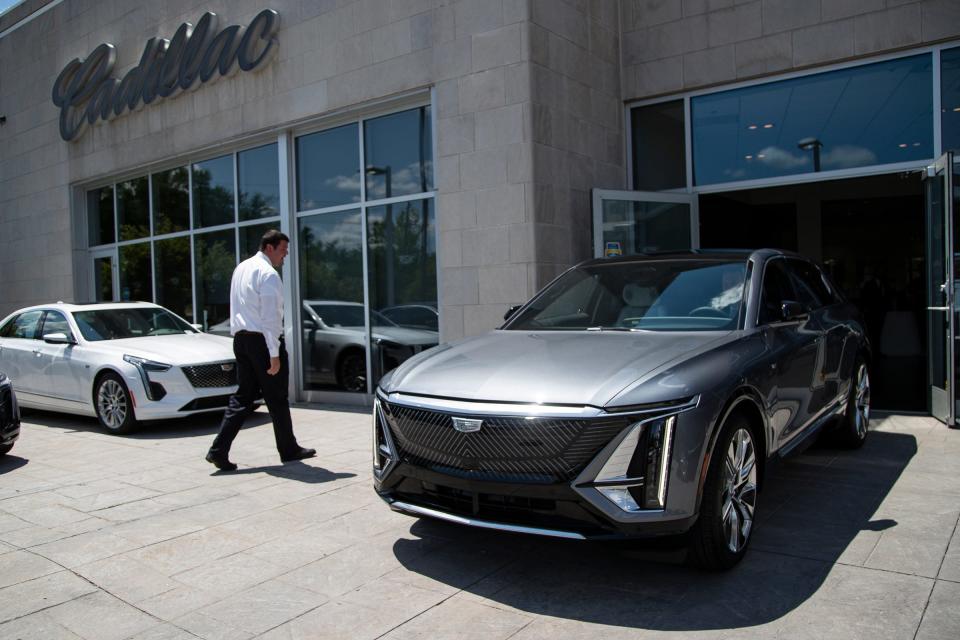 Cadillac of Novi in Michigan general manager Ed Pobur drives the Cadillac Lyriq out of the showroom after delivering it to the customer at the dealership on July 14, 2022.
