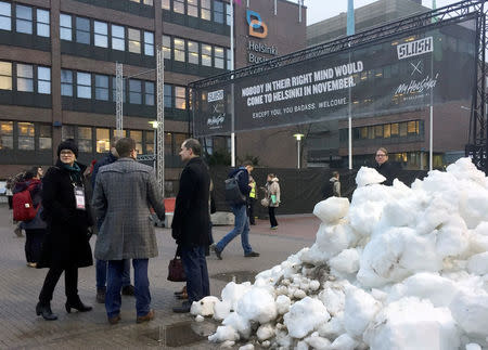 People gather near the entrance to the venue of Slush, one of Europe's biggest tech start-up conferences in Helsinki, Finland November 30, 2016. REUTERS/Mia Shanley