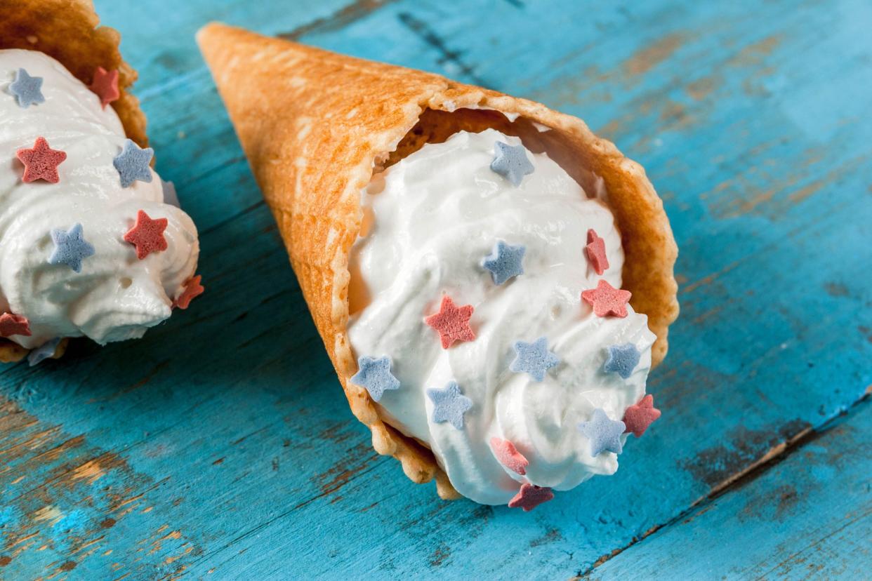 ice cream cone with frosting and red and blue star sprinkles