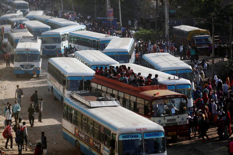 Migrant workers travel in crowded buses as they return to their villages, during a 21-day nationwide lockdown to limit the spreading of coronavirus disease (COVID-19), in Ghaziabad,