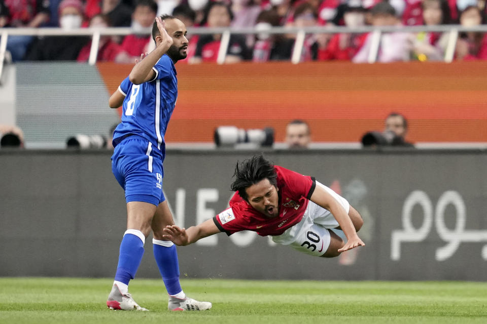 Abdullah Otayf of Saudi Arabia's Al Hilal, left, and Shinzo Kohrogi of Japan's Urawa Red Diamonds, right, collide to fight for the ball during the AFC Champions League final match between Japan's Urawa Red Diamonds and Saudi Arabia's Al Hilal at Saitama Stadium in Saitama, near Tokyo, Saturday, May 6, 2023. (AP Photo/Toru Hanai)