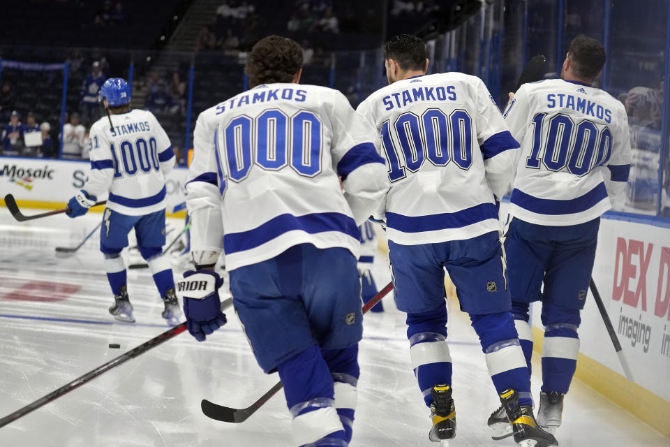 Members of the Tampa Bay Lightning wear Stamkos 1000 jerseys during warmups before an NHL hockey game against the Toronto Maple Leafs Tuesday, April 11, 2023, in Tampa, Fla. The team is honoring Steven Stamkos after he played his 1,000th career game last week. (AP Photo/Chris O'Meara)