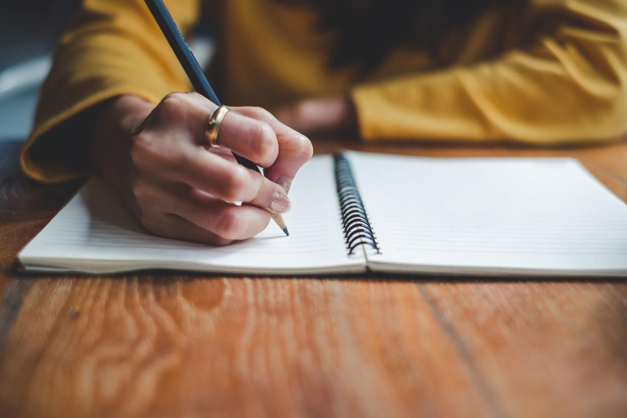 close-up of hands journaling