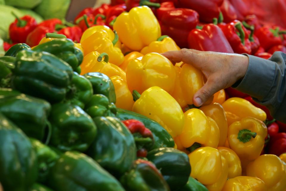 NETANYA, ISRAEL - FEBRUARY 22: A shopper reaches for a yellow pepper in the local produce market February 22, 2006 in Netanya in central Israel. Fresh locally-grown vegetables, a source of antioxidants according to the American Heart Association, feature regularly in meals in Mediterranean countries. The Mediterranean diet, a term used to broadly describe the eating habits of the people of the region, is widely believed to be responsible for the low rates of chronic heart disease in the populations of the 16 countries bordering the Mediterranean Sea. (Photo by David Silverman/Getty Images)