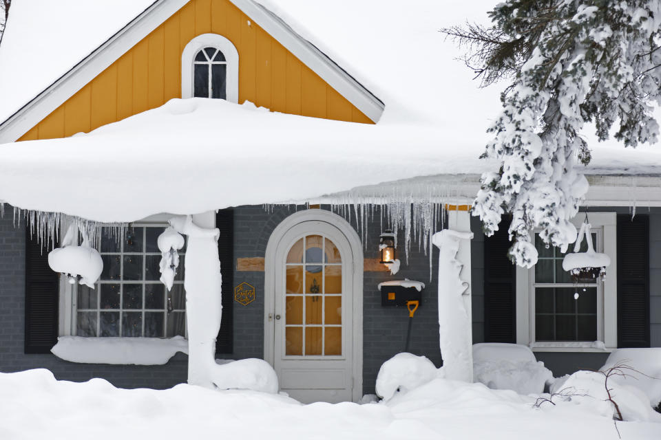 A house covered in snow after a winter storm rolled through Western New York Tuesday, Dec. 27, 2022, in Amherst, N.Y. (AP Photo/Jeffrey T. Barnes)