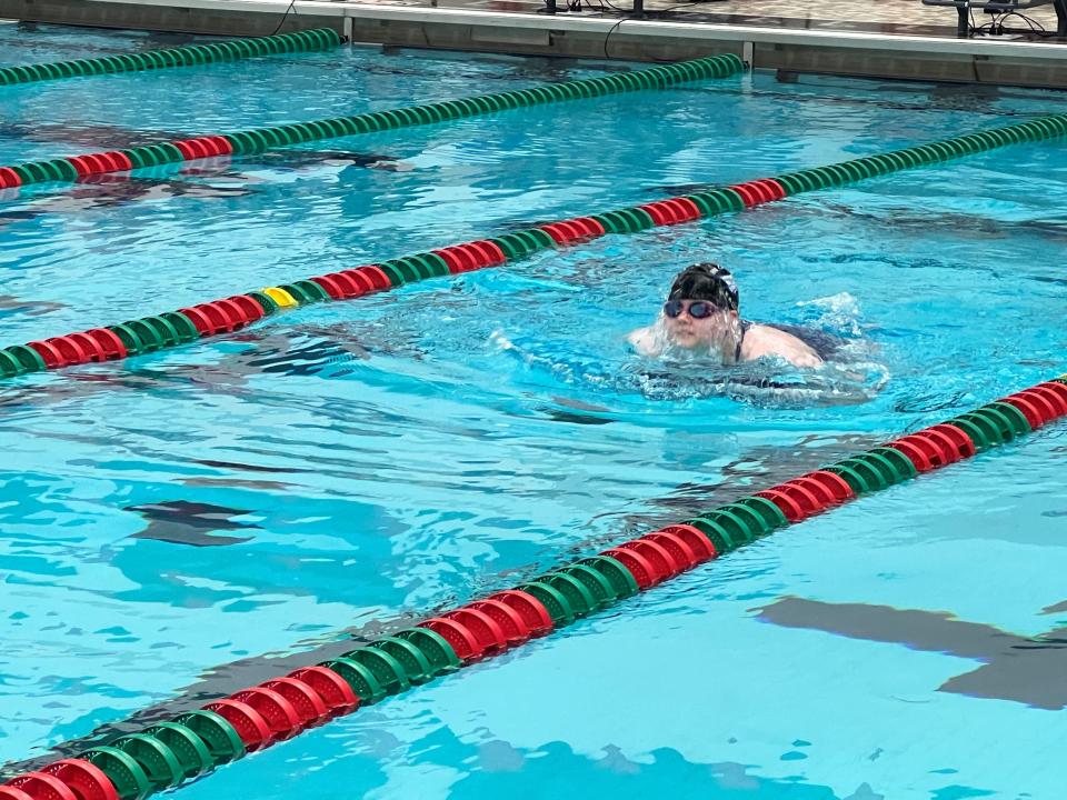 Heritage Christian's Chloe Salsbury doing the breaststroke. She competed Thursday night at sectionals with spina bifida. She rolls her wheelchair to the pool deck, slips into the water and races.