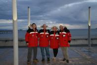 Diego Delgado, Dale Shippam, Heather Ross and Michel White smile in their Outdoor Survival Canada coats.