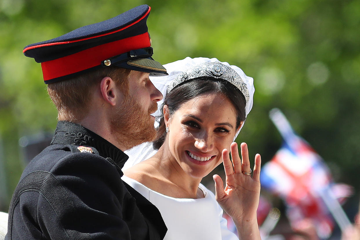 Britain's Prince Harry, Duke of Sussex and his wife Meghan, Duchess of Sussex wave from the Ascot Landau Carriage during their carriage procession on the Long Walk as they head back towards Windsor Castle in Windsor, on May 19, 2018 after their wedding ceremony. (Photo by Daniel LEAL-OLIVAS / AFP)        (Photo credit should read DANIEL LEAL-OLIVAS/AFP via Getty Images)