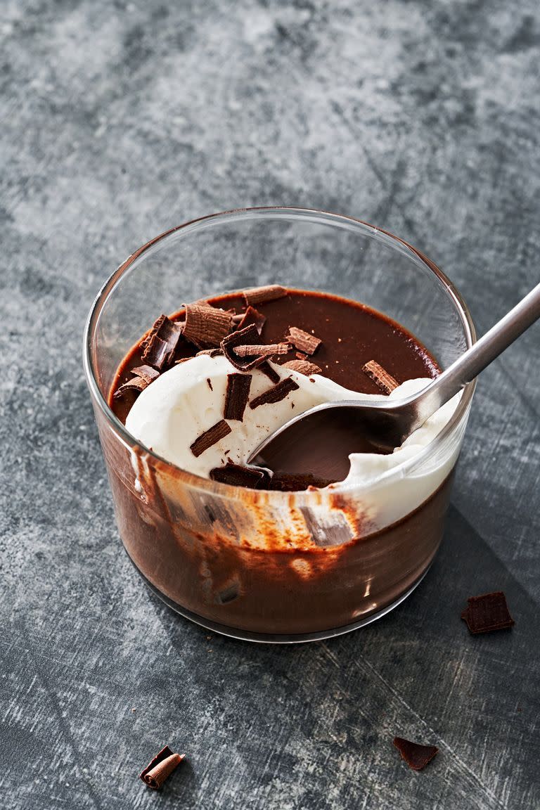 chocolate pot de creme topped with whipped cream and chocolate shavings