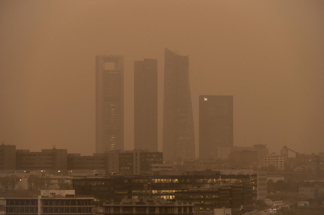 MADRID, SPAIN - 2022/03/15: The skyscrapers of the Four Towers Business Area is seen with mist generated by a high amount of dust particles in suspension coming from the Sahara, causing a decrease in air quality, sand in the streets, a reddish sky and rising temperatures. The Community of Madrid has advised to limit outdoor activities due to the bad air quality. (Photo by Marcos del Mazo/LightRocket via Getty Images)
