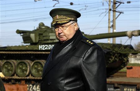 A high ranking Russian officer looks on as Russian tanks arrive at a train station in the Crimean settlement of Gvardeiskoye near the Crimean city of Simferopol March 31, 2014. REUTERS/Yannis Behrakis