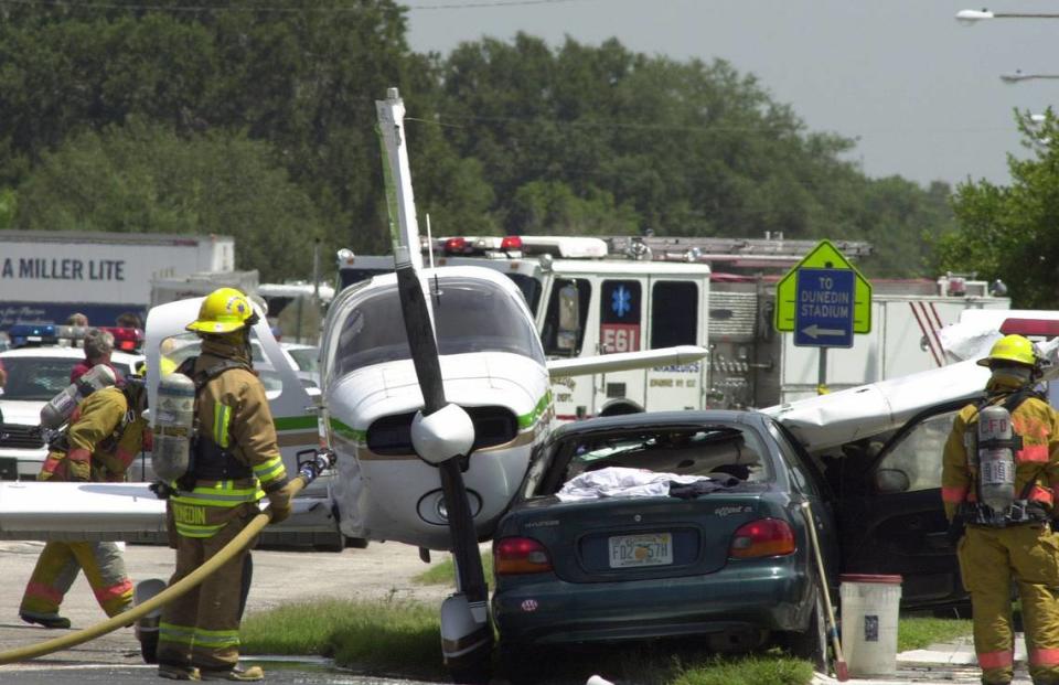 Emergency personnel investigate the scene where a single engine plane landed on top of a car Friday morning June 28, 2002 in Dunedin, Fla. The plane, piloted by off-duty Clearwater Police Cpl. John Long, tried to land on the road after experiencing engine problems, said Marianne Pasha, a spokeswoman for the Pinellas County Sheriff’s Office. Long, and the driver of the car, Christine Meents of Dunedin, were taken to Bayfront Medical Center, said Cassandra Morrell, a spokeswoman there.