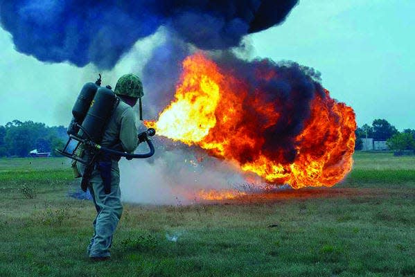 Larry MacLean, of Rochester Hills, Mich., will return to Benton Harbor on Saturday and Sunday for a flame-thrower demonstration at Southwest Michigan Regional Airport. Last year, he displayed flame-throwing equipment used during World War II, shown here. This time, he¿ll trigger a flame-thrower used in the Vietnam War. (Photo provided/DENNIS HAFER)
