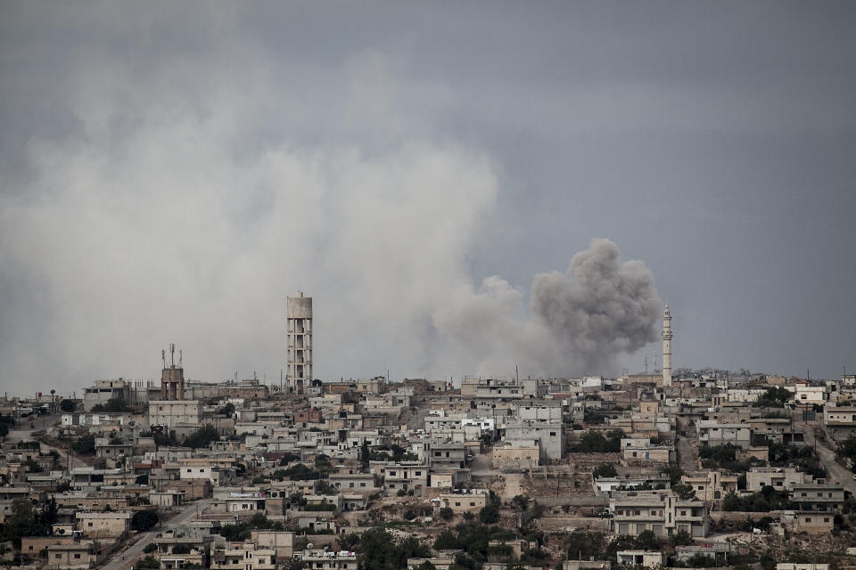 FILE - In this Sept. 19, 2013, file photo, smoke rises after a TNT bomb was thrown from a helicopter, hitting a rebel position during heavy fighting between troops loyal to president Bashar Assad and opposition fighters, in a neighbouring village to Kafr Nabuda, in the Idlib province countryside, Syria. n two months of intensive airstrikes and bombardments on the rebel-controlled province of Idlib, Syrian government forces and their Russian allies have failed to make progress against battle-hardened insurgents. (AP Photo/File)