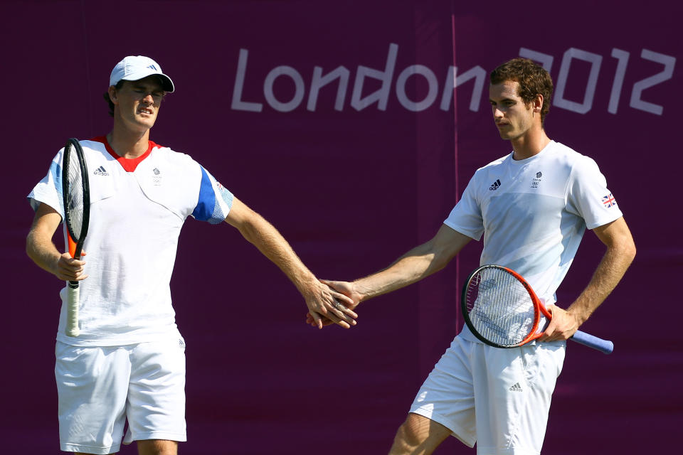 LONDON, ENGLAND - JULY 26: Jamie Murray (L) of Great Britain and his brother Andy Murray (R) react during the practice session ahead of the London 2012 Olympic Games at the All England Lawn Tennis and Croquet Club in Wimbledon on July 26, 2012 in London, England. (Photo by Clive Brunskill/Getty Images)