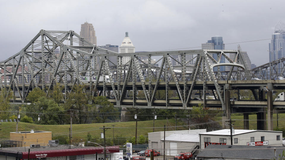 FILE - Traffic on the Brent Spence Bridge passes in front of the Cincinnati skyline while crossing the Ohio River to and from Covington, Ky., Oct. 7, 2014. According to a recent announcement by Kentucky and Ohio they will receive more than $1.63 billion in federal grants to help build a new Ohio River bridge near Cincinnati and improve the existing overloaded span there, a heavily used freight route linking the Midwest and the South. (AP Photo/Al Behrman, File)