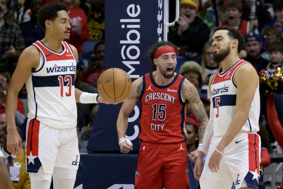 New Orleans Pelicans guard Jose Alvarado (15) celebrates a basket and a foul shot thanks to Washington Wizards guard Tyus Jones (5) during the second half of an NBA basketball game in New Orleans, Wednesday, Feb. 14, 2024. (AP Photo/Matthew Hinton)