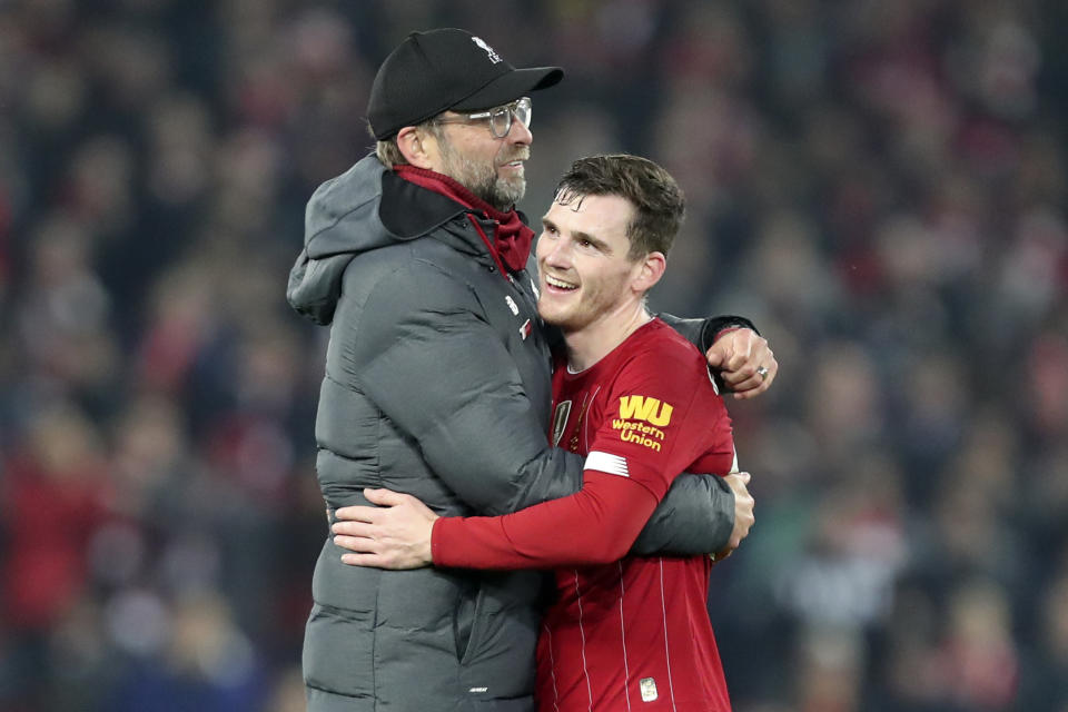 Liverpool's manager Jurgen Klopp embraces Liverpool's Andrew Robertson at the end of the English Premier League soccer match between Liverpool and Wolverhampton Wanderers at Anfield Stadium, Liverpool, England, Sunday Dec. 29, 2019. Liverpool won 1-0. (AP Photo/Jon Super)
