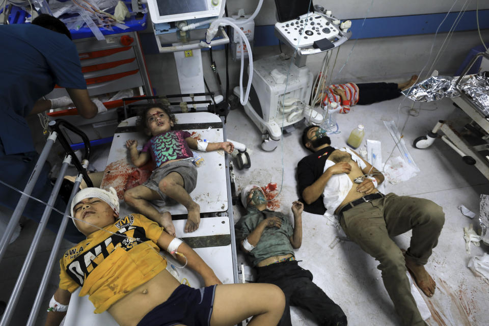 Palestinians wounded in the Israeli bombardment wait for treatment in Shifa Hospital in Gaza City, Monday, Oct. 23, 2023. (AP Photo/Yasser Qudih)