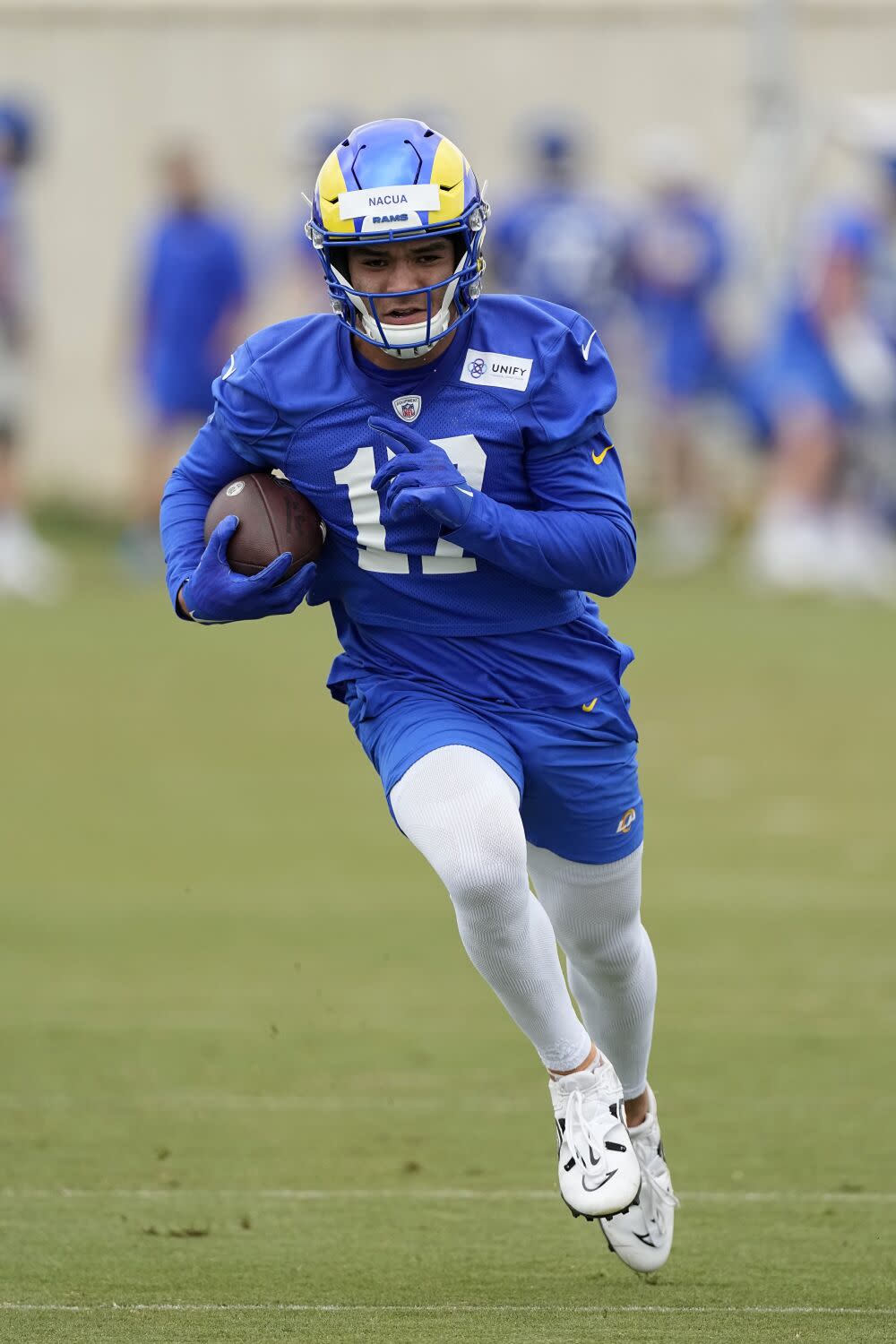 Rams rookie receiver Puka Nacua runs after a catch at minicamp.