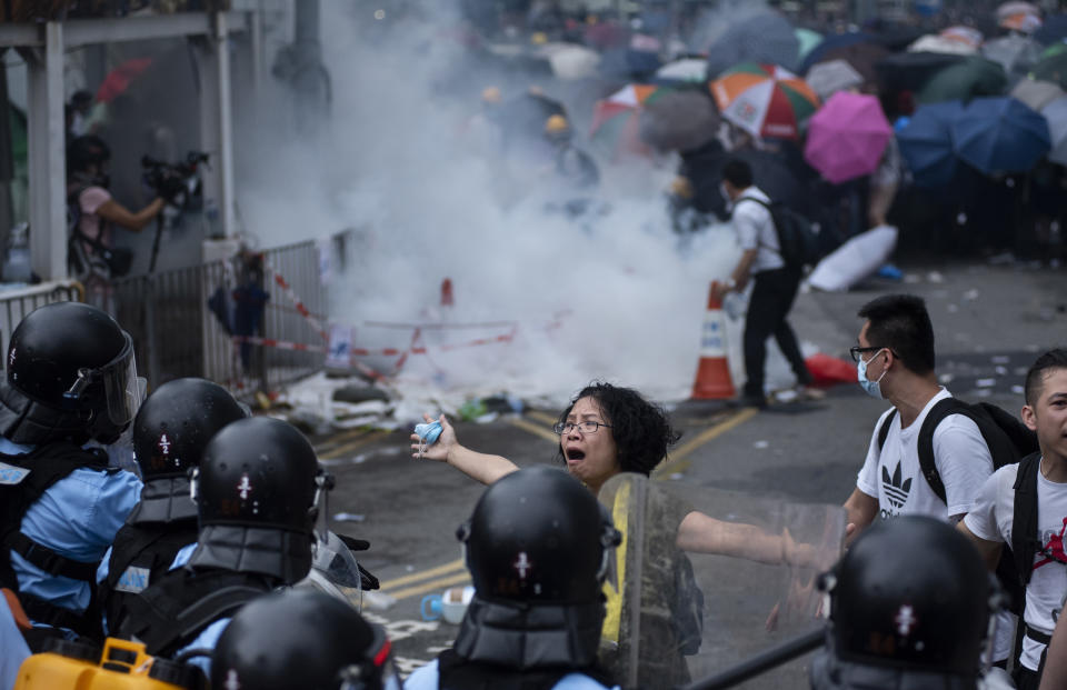 ADMIRALTY, HONG KONG - 2019/06/12: A protester tries desperately to convince police officers to stop using force against them during the demonstration. Thousands of protesters occupied the roads near the Legislative Council Complex in Hong Kong to demand to government to withdraw extradition bill. The Hong Kong government has refused to withdraw or delay putting forward the bill after tens of thousands of people marched against it on Sunday. (Photo by Miguel Candela/SOPA Images/LightRocket via Getty Images)