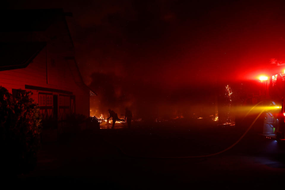 Firefighters work to contain a burning structure during the wind-driven Kincade Fire in Windsor, California, Oct. 27, 2019. (Photo: Stephen Lam/Reuters)