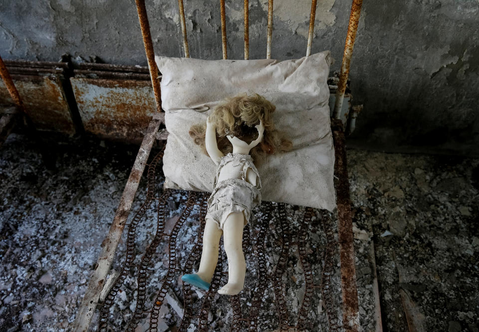 A vintage doll, which was placed by a visitor, is seen on a bed at a kindergarten near the Chernobyl nuclear power plant in the abandoned city of Pripyat, Ukraine April 5, 2017. Picture taken April 5, 2017. REUTERS/Gleb Garanich