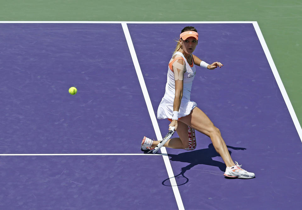 Agnieszka Radwanska, of Poland, returns to Dominika Cibulkova, of Slovakia, at the Sony Open Tennis tournament in Key Biscayne, Fla., Wednesday, March 26, 2014. (AP Photo/Joel Auerbach)