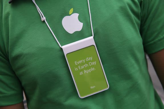An Apple employee greets customers on Earth Day, April 22, 2014.