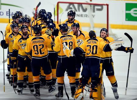 Nashville Predators players celebrate after a win in game three against the San Jose Sharks of the second round of the 2016 Stanley Cup Playoffs at Bridgestone Arena. The Predators won 4-1. Mandatory Credit: Christopher Hanewinckel-USA TODAY Sports