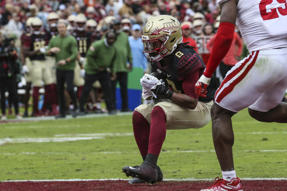 Florida State running back Treshaun Ward (8) scores a touchdown with a one-yard run during the second quarter of an NCAA college football game against Louisiana on Saturday, Nov. 19, 2022, in Tallahassee, Fla. (AP Photo/Gary McCullough)
