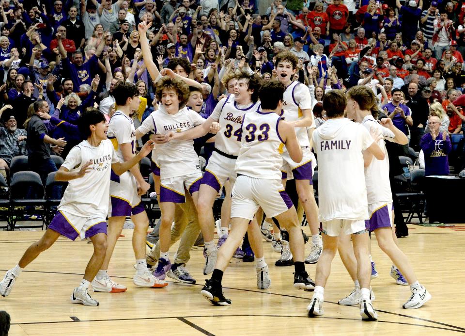 Williamsville players celebrate their win over Macomb at the conclusion of the game Monday, March 4, 2024.