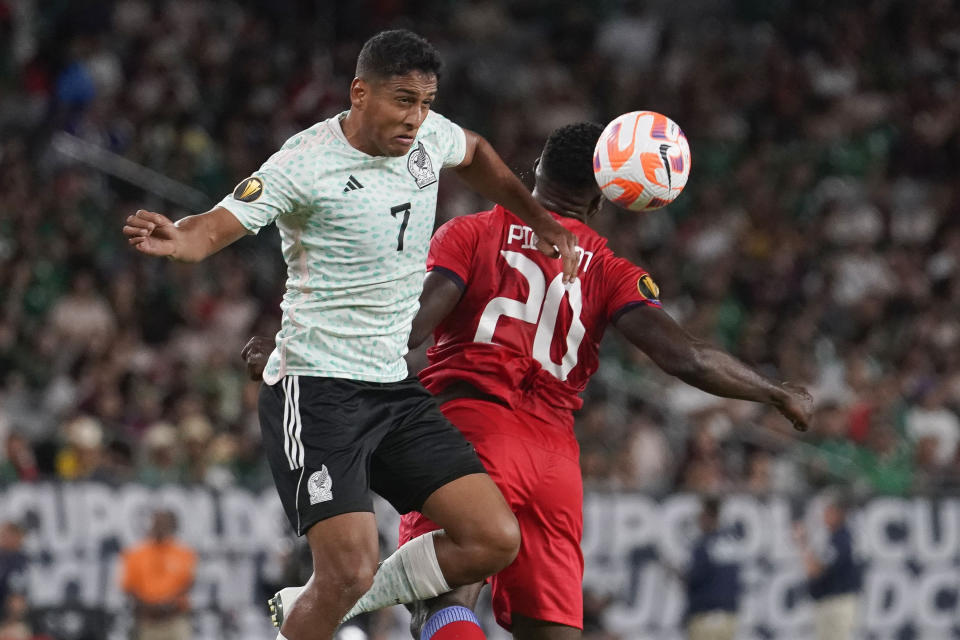 Mexico's Luis Romo (7) wins a head ball against Haiti's Frantzdy Pierrot (20) during the first half of a CONCACAF Gold Cup soccer match Thursday, June 29, 2023, in Glendale, Ariz. (AP Photo/Darryl Webb)